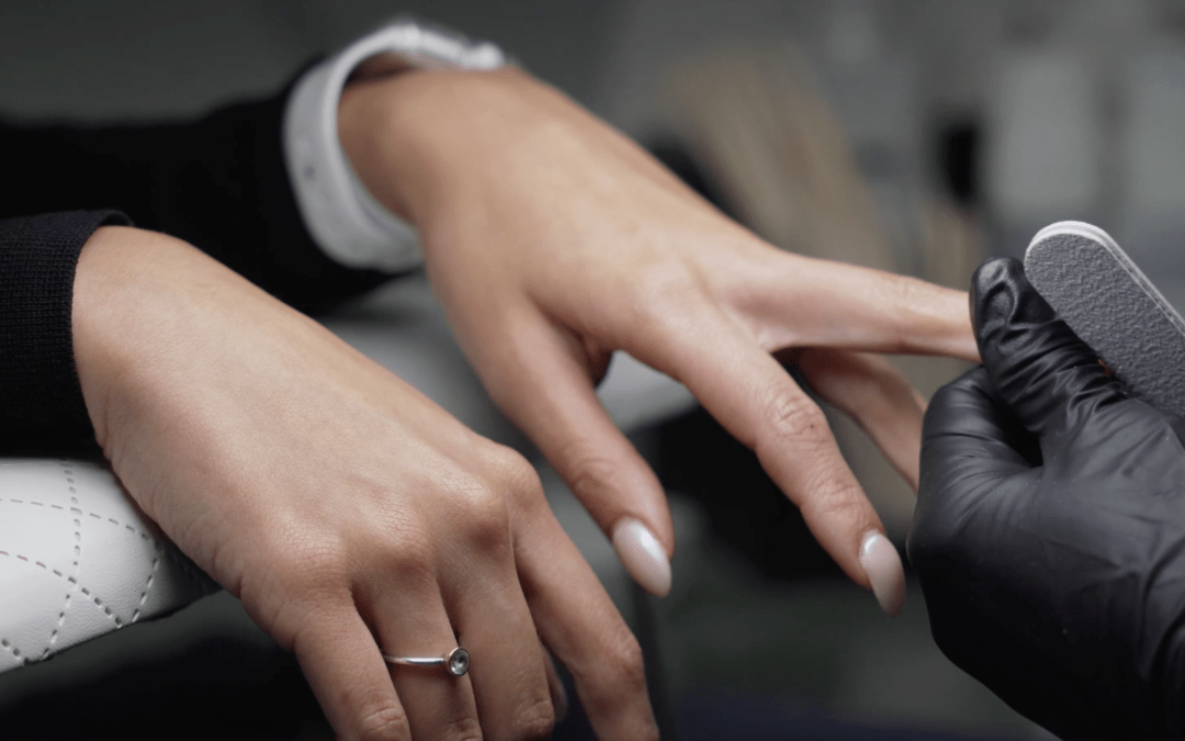 "Student becoming an esthetician and practicing a nail care service"