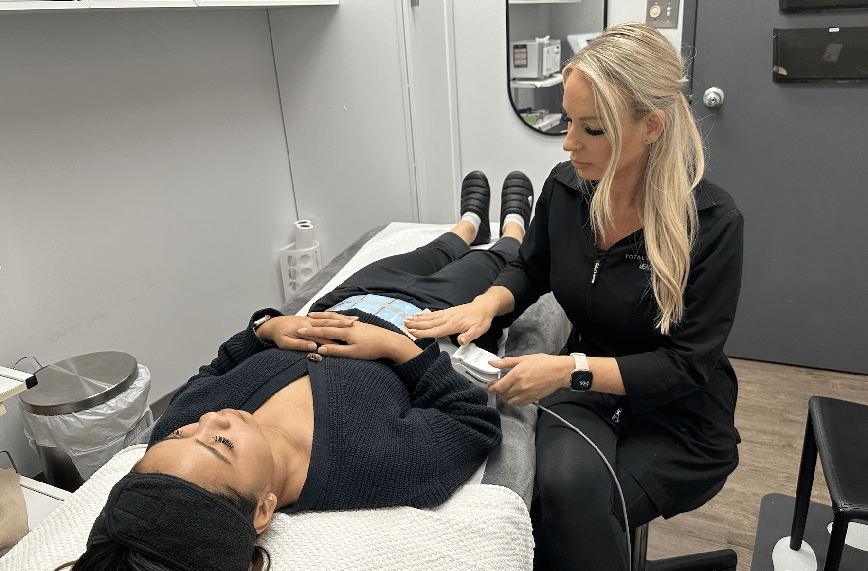Esthetician performing an rf body contouring service on a client