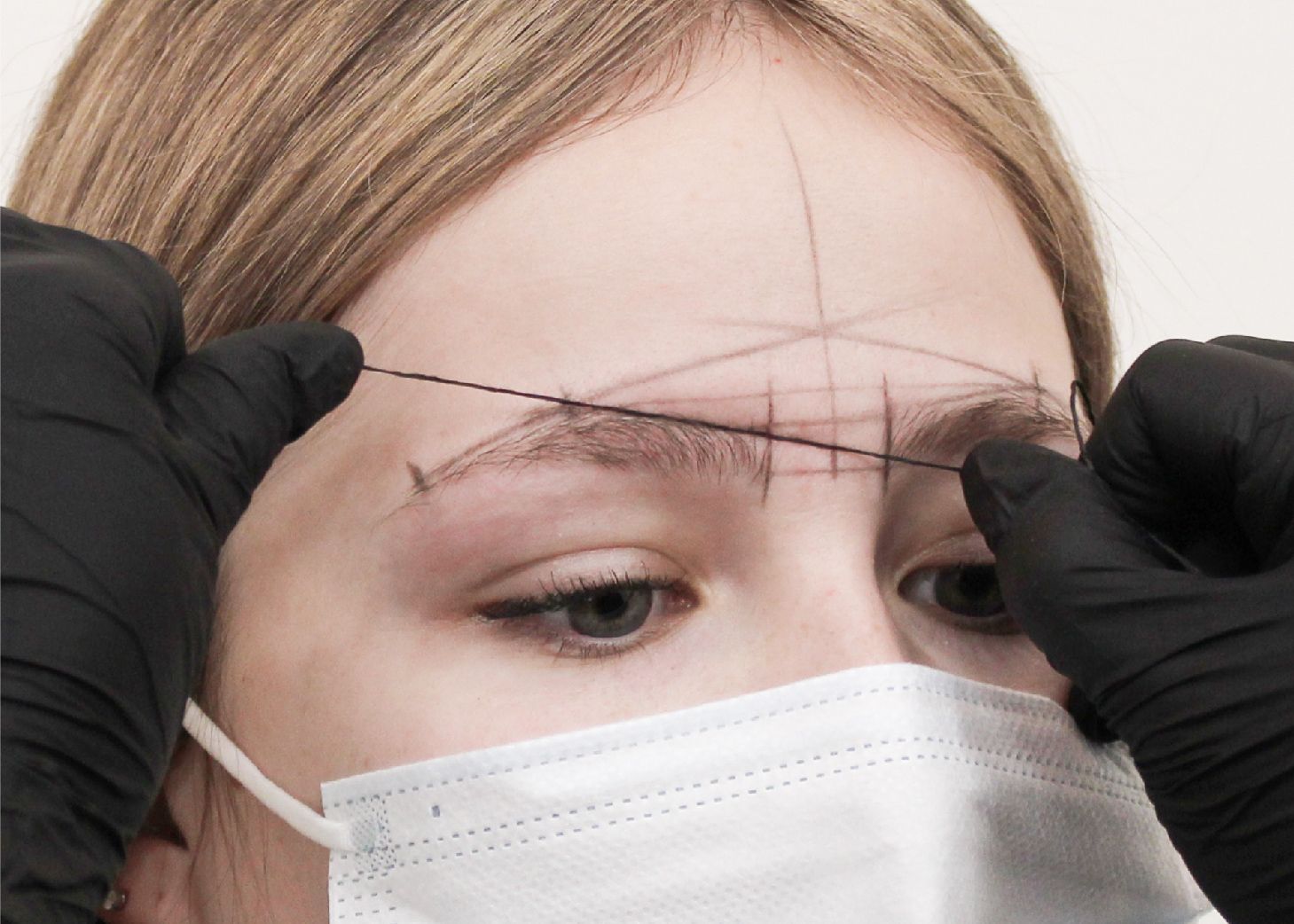 Woman receiving brow mapping treatment