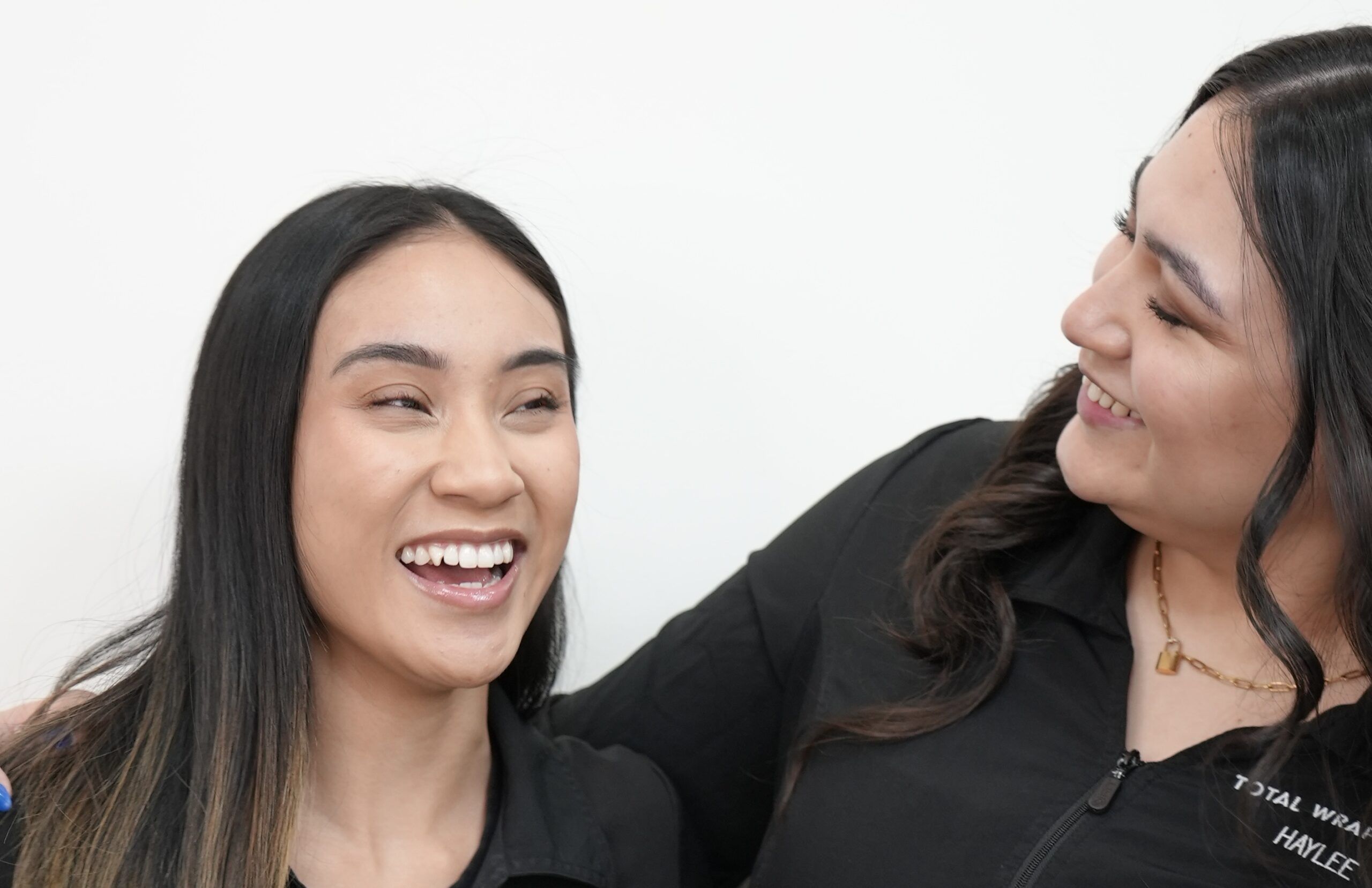 client and esthetician laughing together