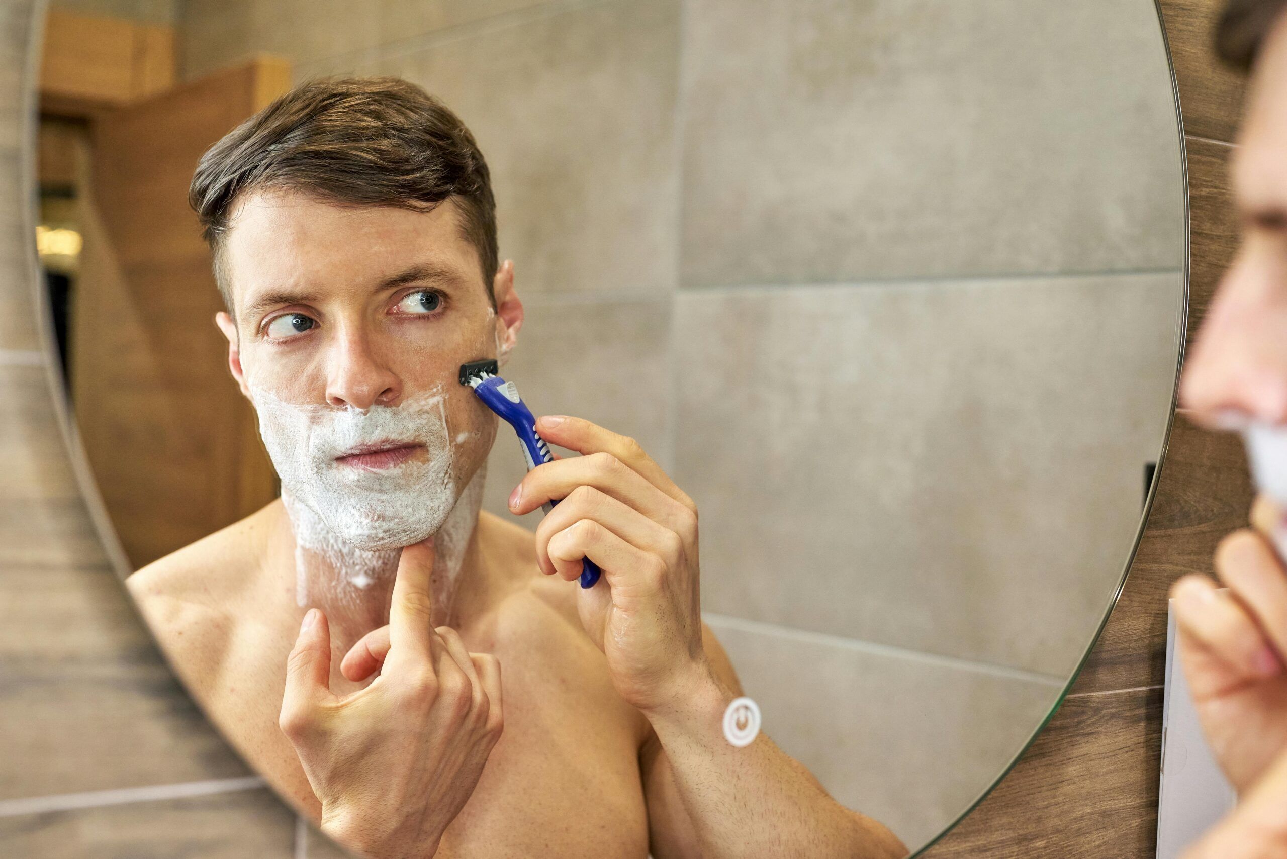 "man shaving face"