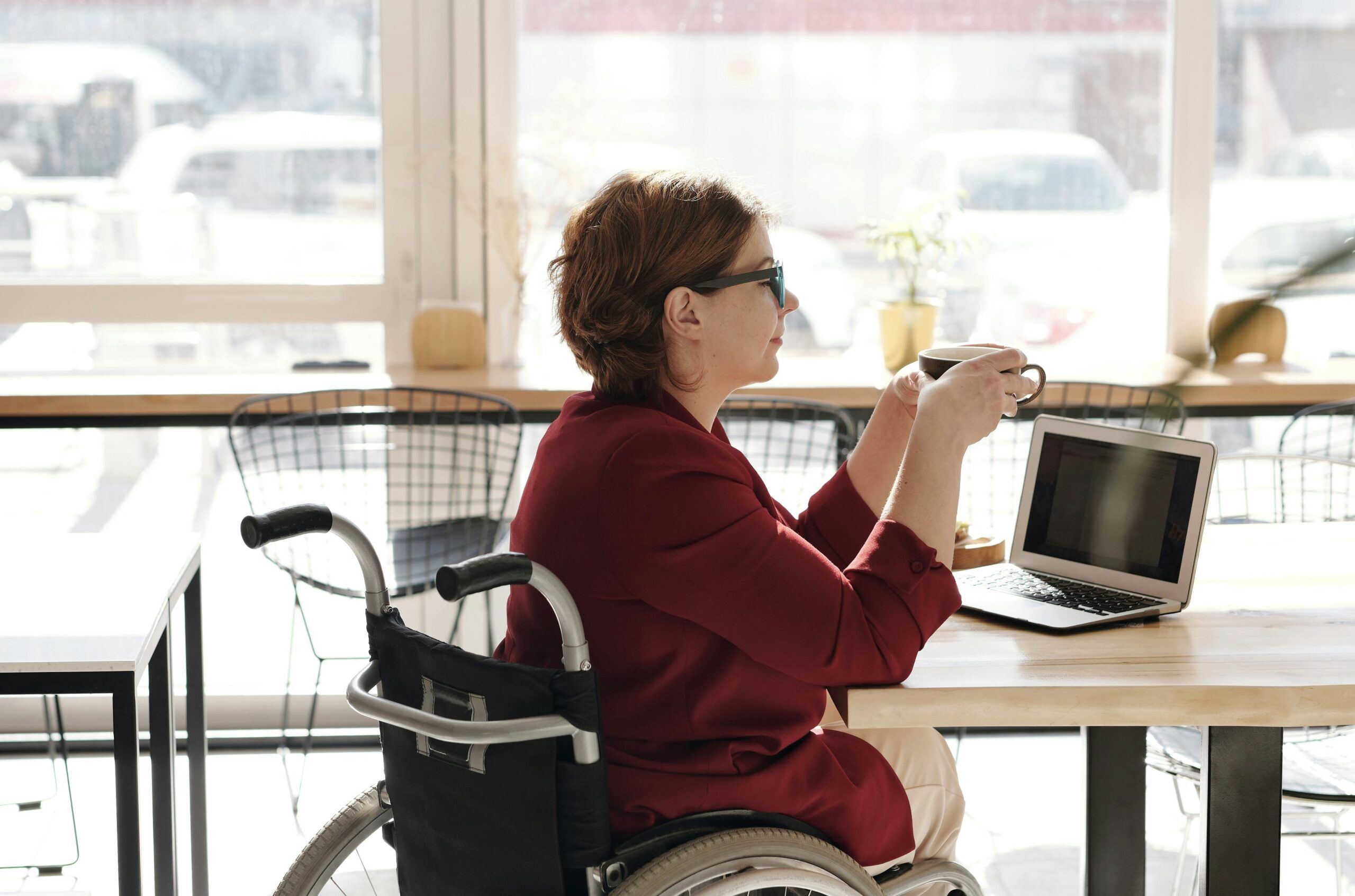 "A student concentrating on beauty school theory lessons on a laptop"