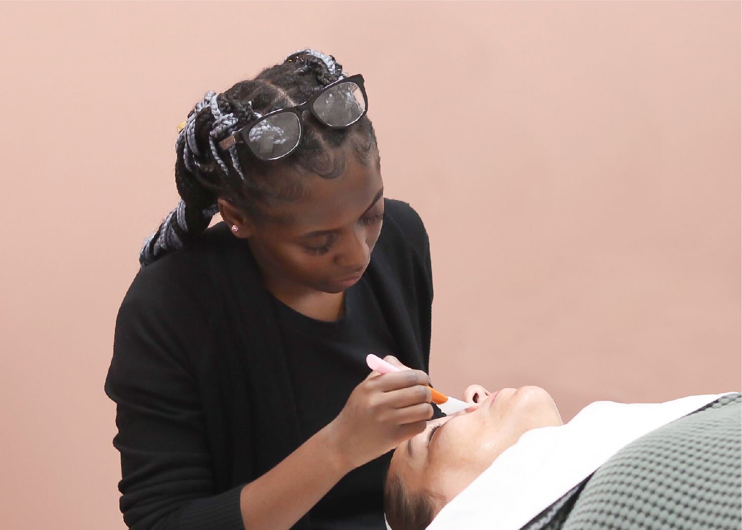 Student performing facial on client