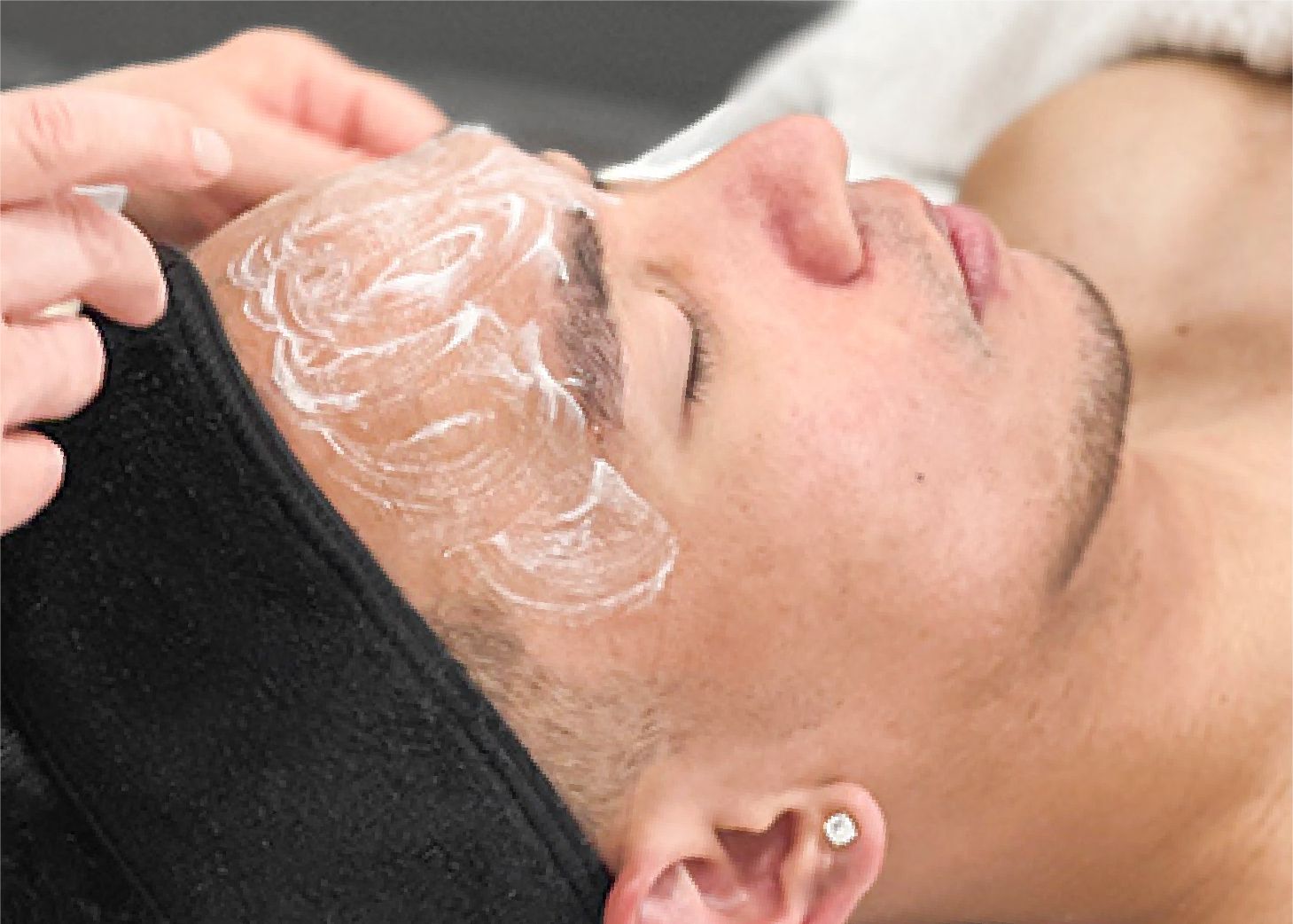 Male client receiving facial at Wrapture Beauty Academy