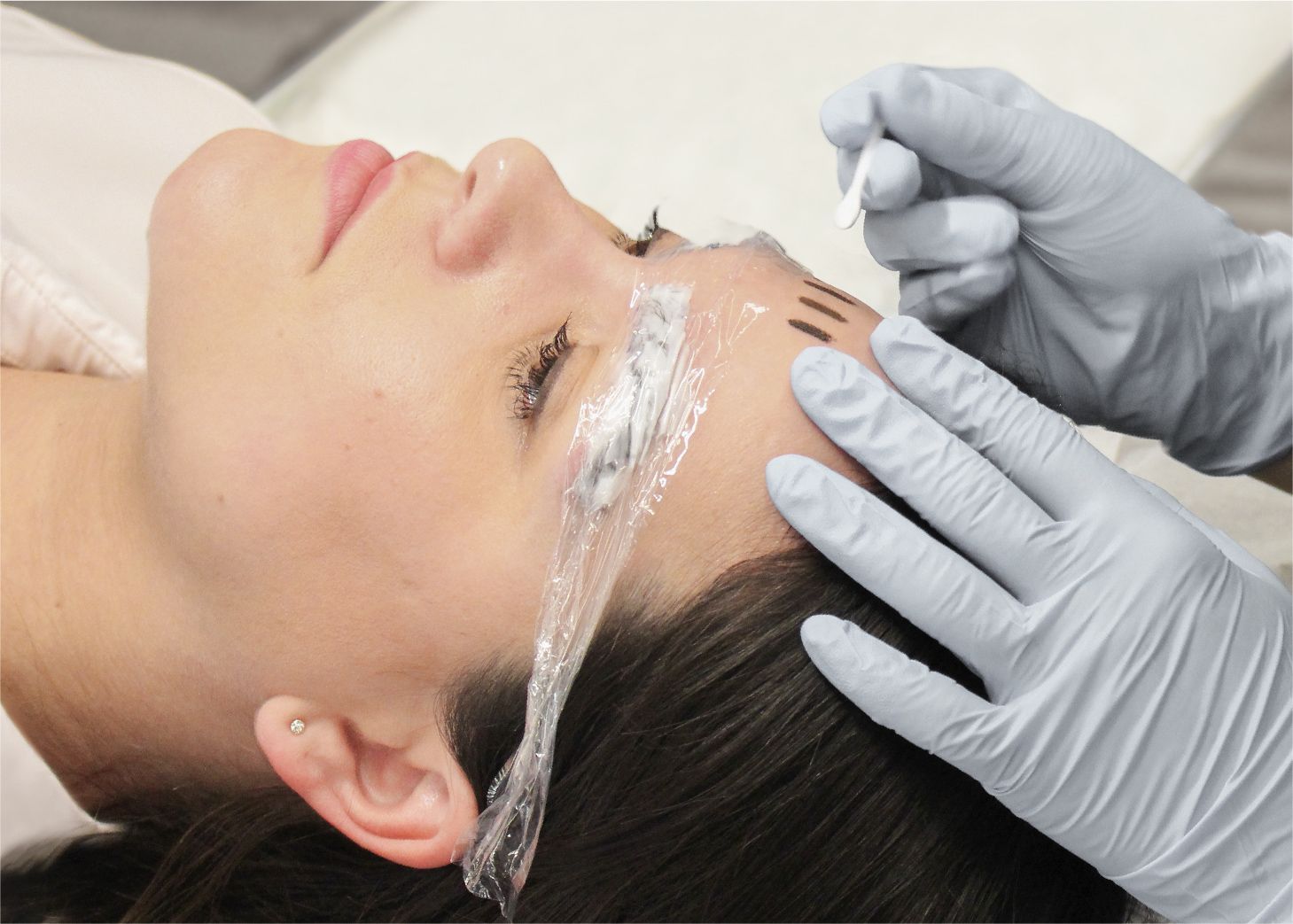 Student apply brow henna dye on model