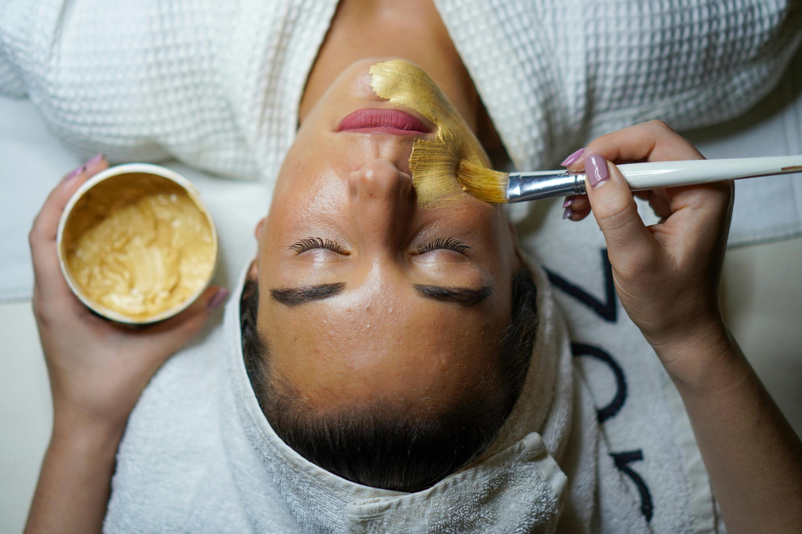 "esthetician branding picture of client having a facial"