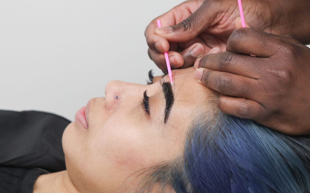 Client receiving brow tinting treatment at Wrapture Beauty Academy