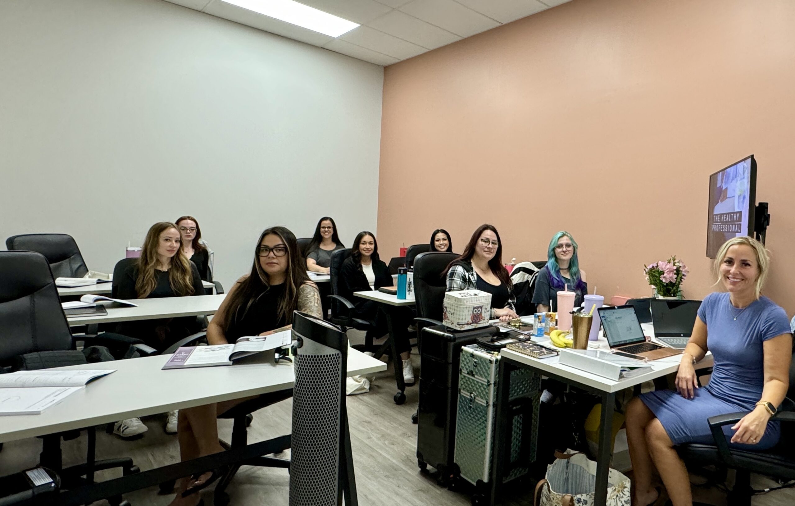 Wrapture beauty academy students faculty community members in class