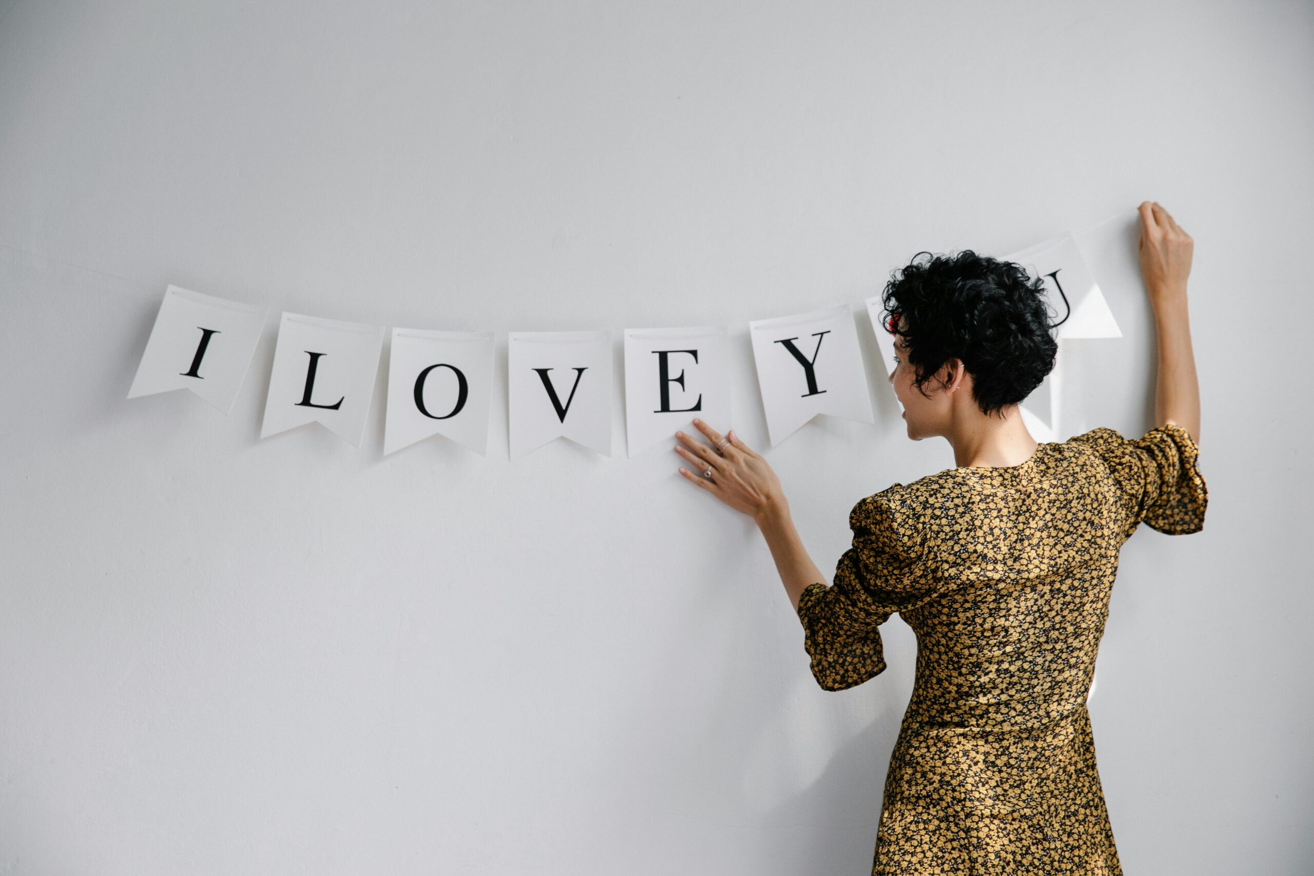 Person stringing up galentine's day decor